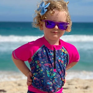 Girl in colourful swimwear and purple sunglasses