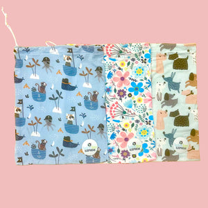 Three fabric swatches with different patterns on a wooden surface