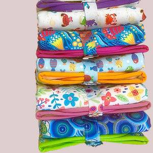 Stack of colorful rolled up change mats