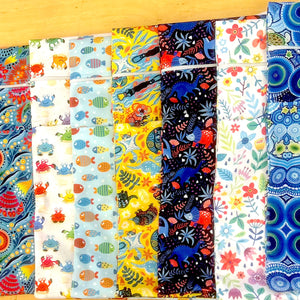 Collection of colorful fabric swatches arranged in a grid on a wooden surface.