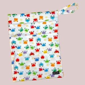Colorful crabs patterned wetbag on a wooden surface