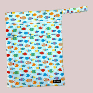 Reusable wet dry bag with colorful fish pattern on a light grey surface
