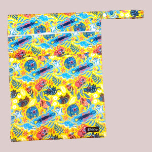 Colorful wet bag with cartoon designs on a blue surface