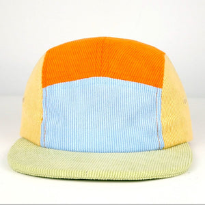 Color-blocked bucket hat with orange, blue, and green sections on a white background