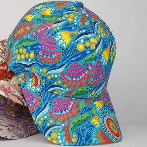 Two colorful patterned caps on a light gray background