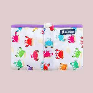 Colorful crab-patterned change mat with a visible brand logo on a white background