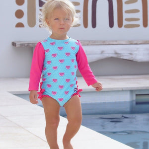 baby-girl-standing-in-watermelon-print-bathers