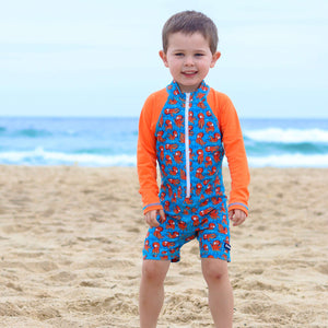 todler-boy-standing-in-easy-change-all-in-one-blue-and-orange-swimwear