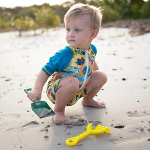 baby-boy-playing-in-short-sleeve-zip-up-animalia-swimsuit