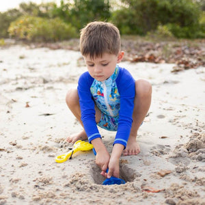 toddler-boy-digging-in-adorable-koala-swimsuit