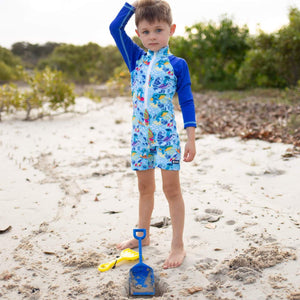 boy-at-beach-wearing-koala-print-swimsuit