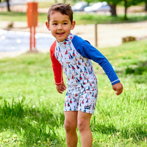 hapy-toddler-boy-standing-in-sun-safe-colourful-swimwear